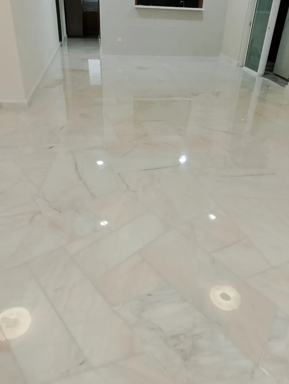 White Marble Floor Overhead Lights Reflection